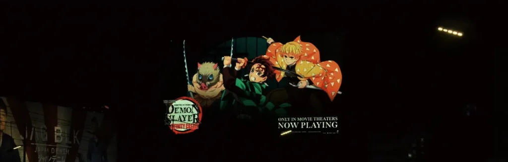 Nighttime Digital Billboard ad for the Demon Slayer: Infinity Castle Arc movie featuring the main characters in a battle stance, with the text "ONLY IN MOVIE THEATERS NOW PLAYING."