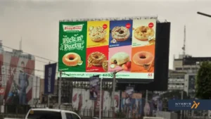 Krispy Kreme digital billboard ad for "Pick n' Party," showing six different donut varieties including Blueberry Cake, White Choco, and Red Velvet.