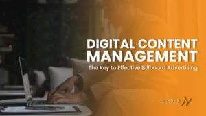A professional man in a tan blazer working on a laptop in a cafe or office setting. The overlay text reads 'Digital Content Management: The Key to Effective Billboard Advertising,' along with the Nyxsys Philippines logo.