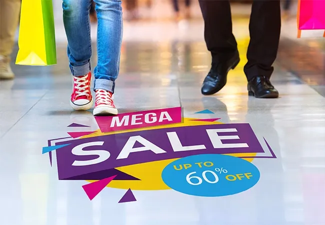mega sale discount advertisement plastered on mall floor.